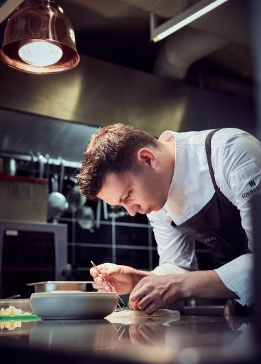 Hotel chef arranges the food