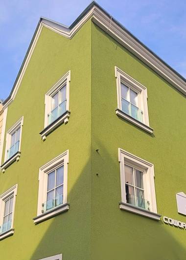 Green house facade with logo of Coup company