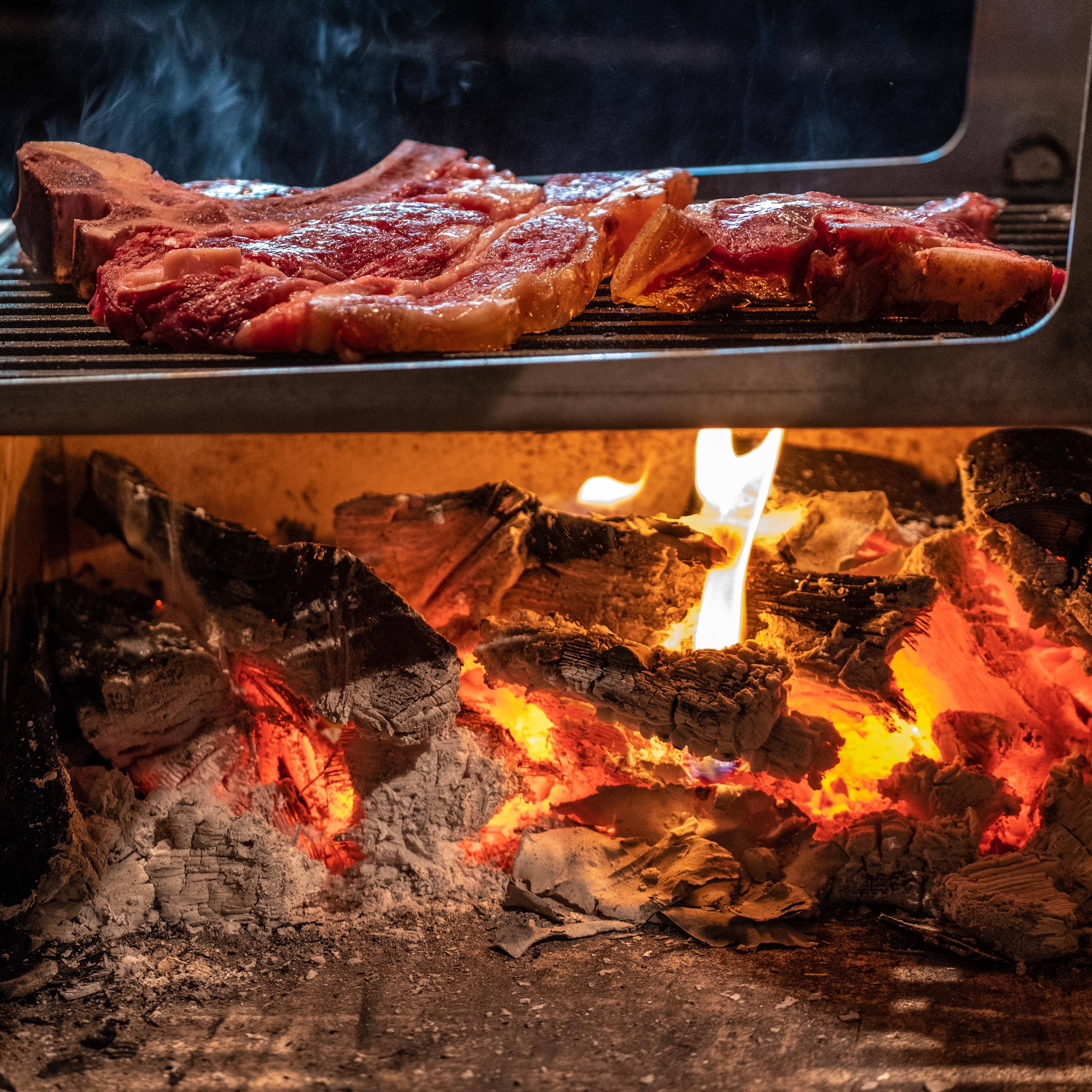 Fresh steaks on an open grill