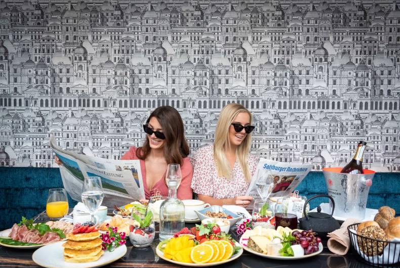 best friends reading the newspaper while having breakfast
